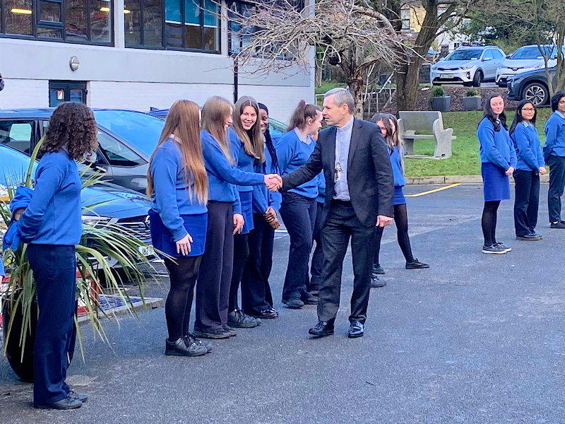 Bishop Fintan is greeted by student representatives on arrival at Christ the King Secondary School