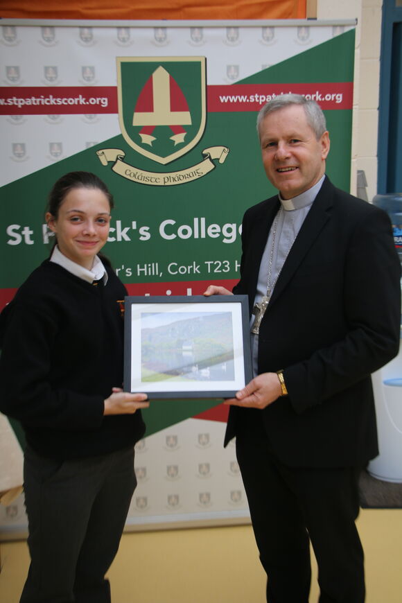 Head Girl Aoife O'Neill presenting Bishop Fintan with a photo of Gougane Barra