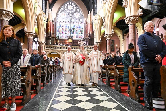 The Blessed Sacrament is brought in processioninto Ss Peter and Paul's Church by Bishop Fintan, accompanied by Deacon Frank McKevitt and Deacon John Guirey
