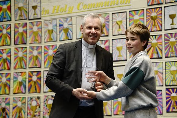 A Pupil from Scoil an Chroí Naofa Presents Gift to Bishop Fintan on behalf of the Pupils and School Community