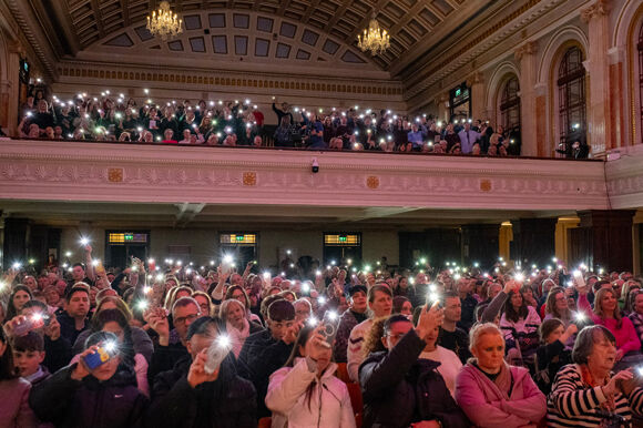 A packed City Hall joined in singing and applauding the young people