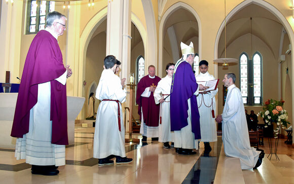 At the Cathedral of St. Mary and St. Anne, Cork, Paul Ryan kneels before Bishop Fintan as he is instituted as an Acolyte.